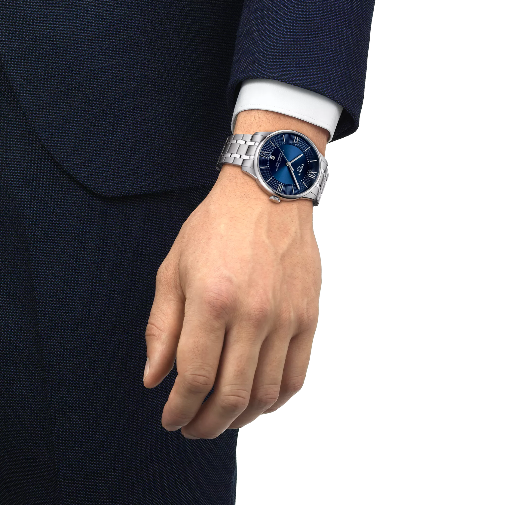 Tissot Chemin Des Tourelles watch worn on wrist with blue dial visible