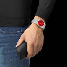 Tissot PRX quartz watch worn on wrist with red dial visible