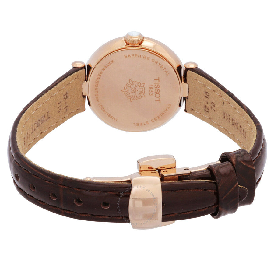 Caseback view of Tissot watch showing rose gold case and brown leather strap with buckle