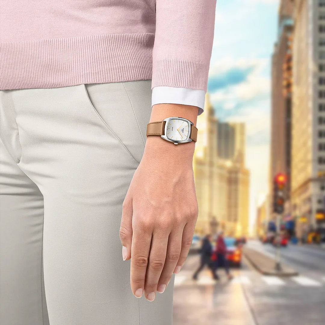 Tissot Stylist watch worn on wrist showing silver dial with brown leather strap