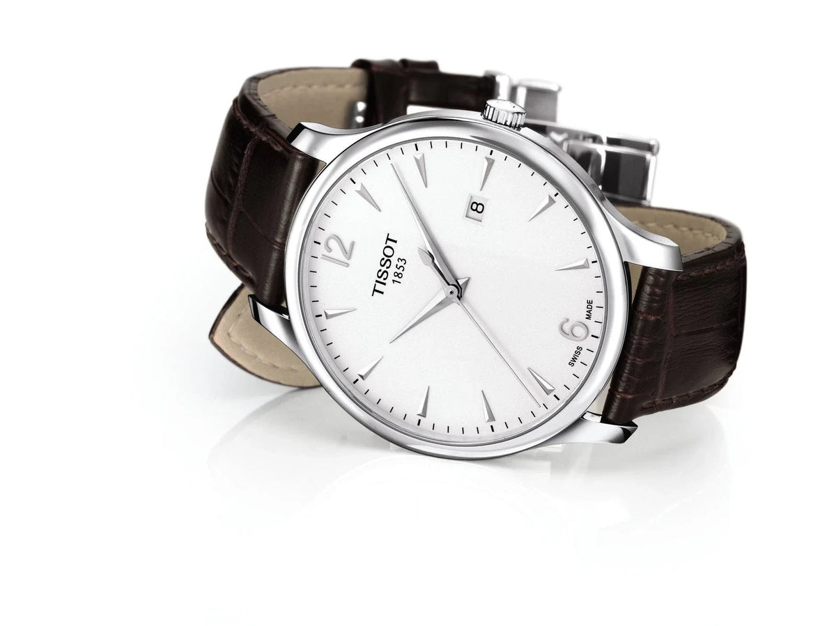 Tissot T Classic Tradition watch displayed at angle showing case and brown strap