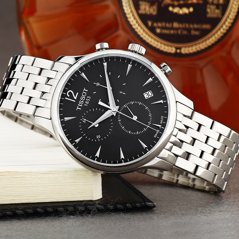Tissot Tradition chronograph watch displayed with branded box and accessories