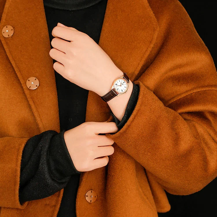 Tissot Tradition watch worn on wrist with white dial and Roman numeral markers