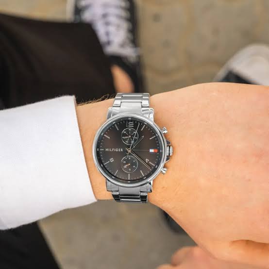 Tommy Hilfiger chronograph men's watch on wrist with black dial and silver metal bracelet