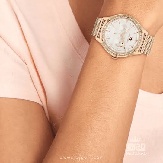 Tommy Hilfiger women's watch with grey dial and golden mesh strap worn on wrist
