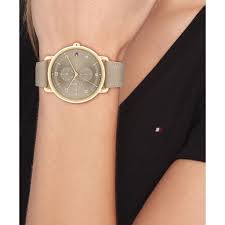 Tommy Hilfiger women's beige dial watch worn on wrist with gold-tone case