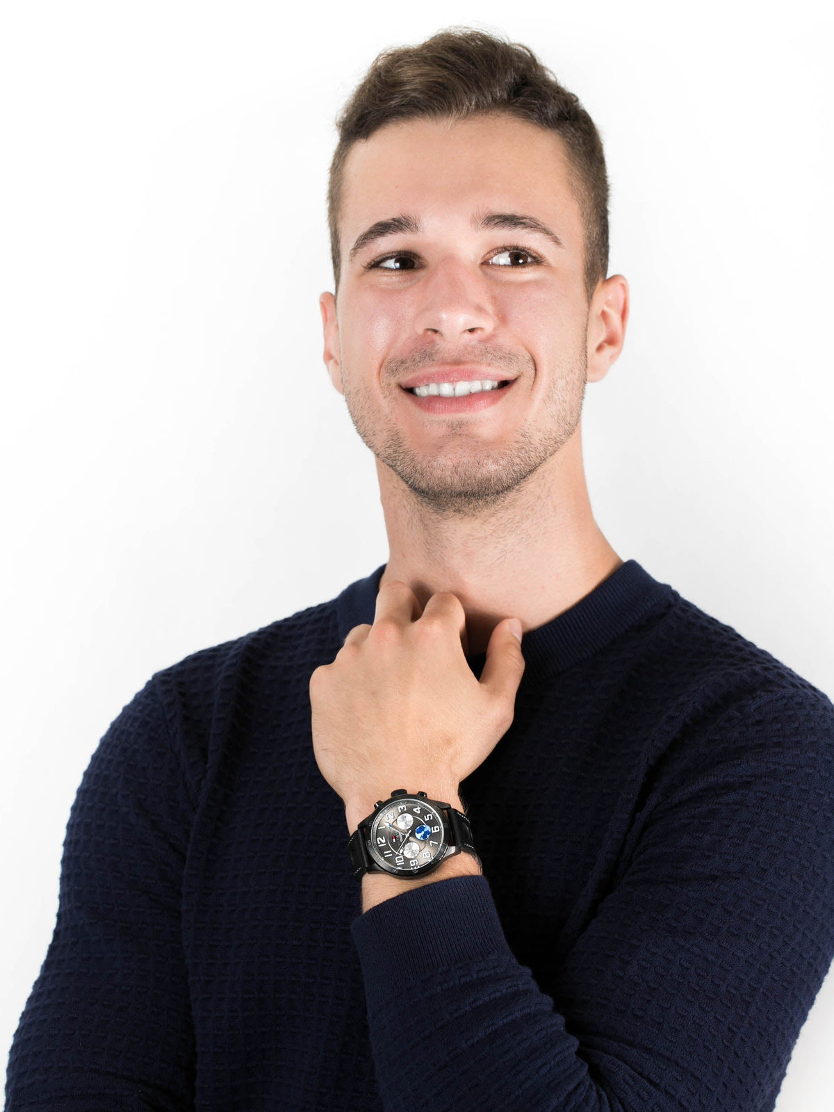 Tommy Hilfiger multi-function watch worn on wrist with black leather strap