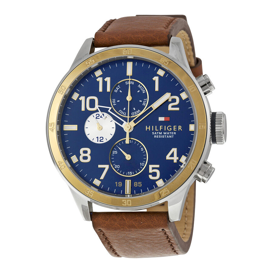 Tommy Hilfiger multi-function chronograph watch with navy blue dial, gold bezel, and brown leather strap