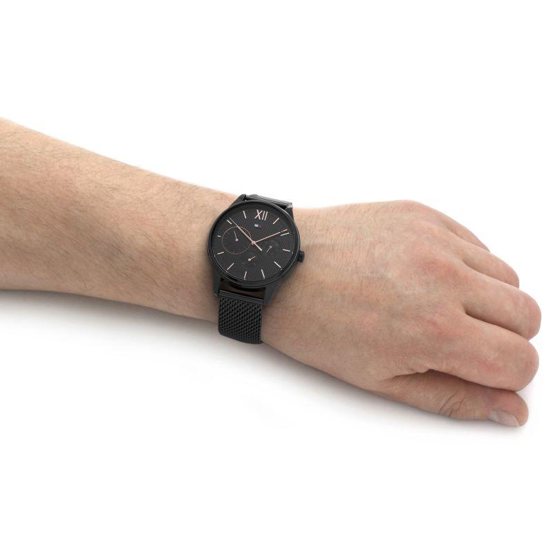 Black chronograph watch with mesh strap displayed on male wrist