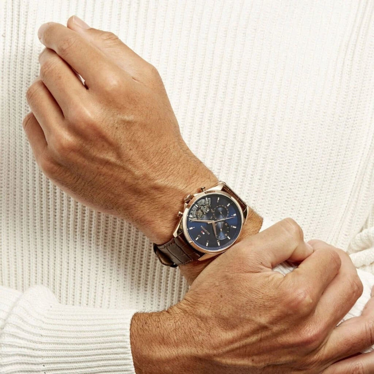 Tommy Hilfiger Baker chronograph watch worn on wrist with cream sweater