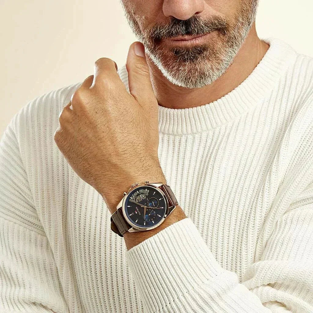 Tommy Hilfiger Baker watch on wrist showing blue chronograph dial and brown leather