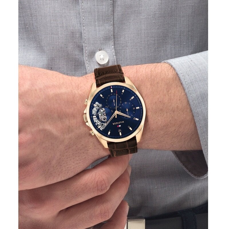 Tommy Hilfiger Baker chronograph watch worn on man's wrist with dress shirt