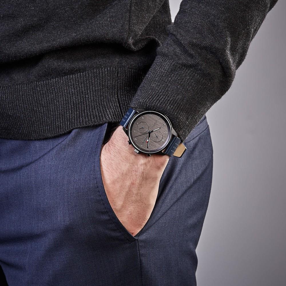 Men's chronograph watch with blue leather strap worn on wrist