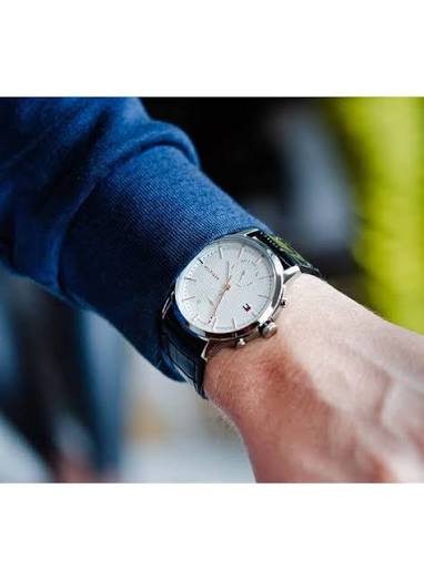 Tommy Hilfiger Chase men's chronograph watch worn on wrist with blue sweater