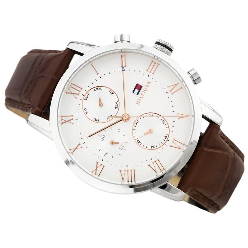 Side angle view of chronograph watch with brown leather strap and pushers