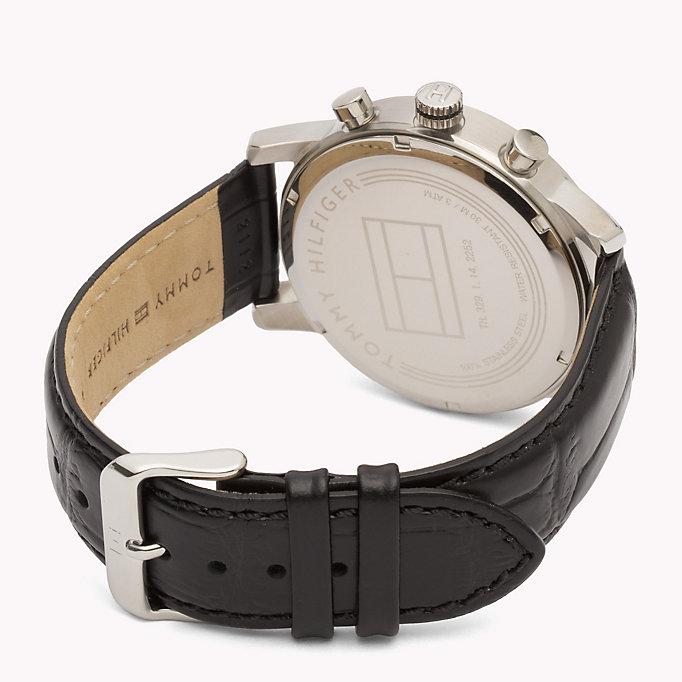 Watch caseback showing Tommy Hilfiger branding and leather strap detail