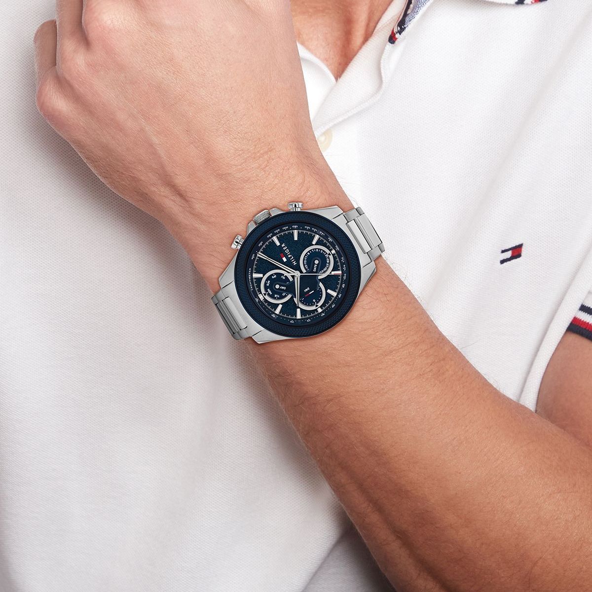 Tommy Hilfiger Clark chronograph watch worn on wrist with blue dial and silver steel bracelet