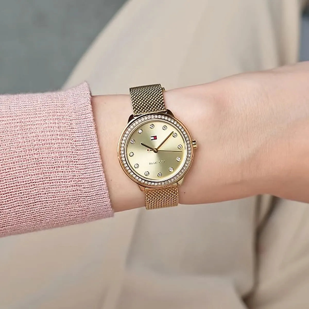 Tommy Hilfiger Demi watch worn on wrist with gold mesh bracelet and gold dial