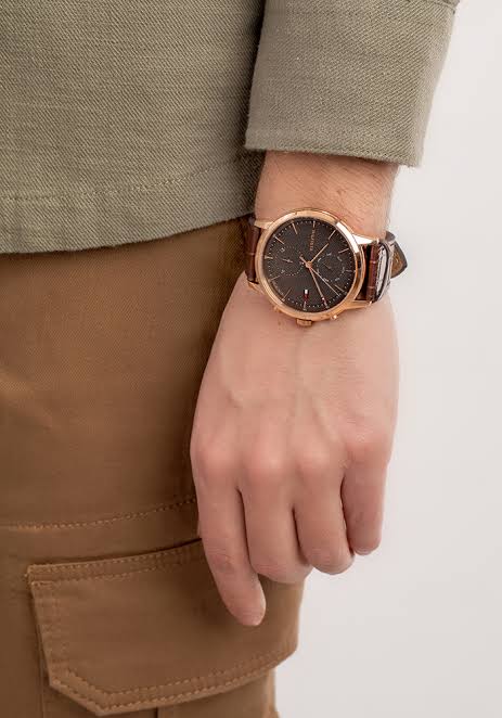 Tommy Hilfiger Easton watch worn on wrist with grey dial and brown leather strap