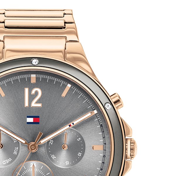 Three-quarter view of rose gold-tone chronograph watch with metal band and grey dial