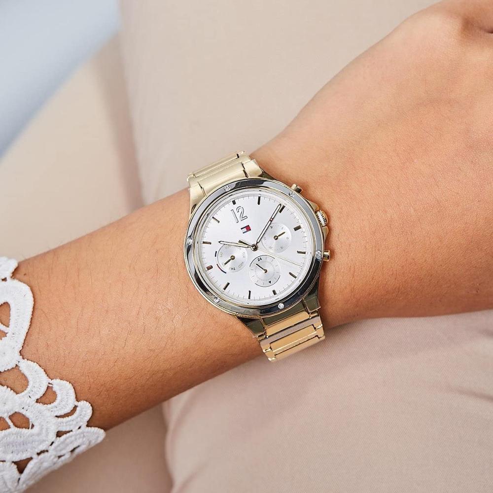Tommy Hilfiger Eve women's watch worn on wrist showing gold-tone case with white multi-dial face
