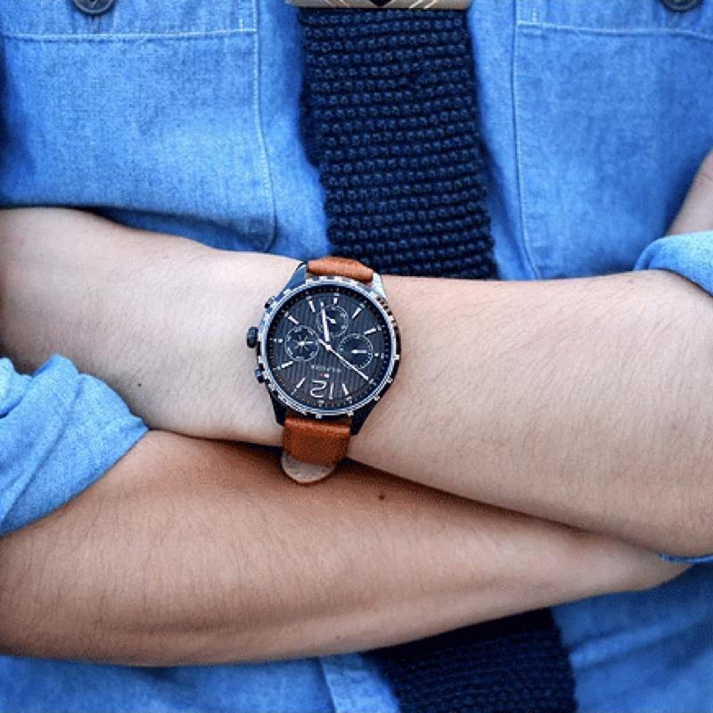 Tommy Hilfiger Gavin chronograph watch worn on wrist with black dial and tan strap