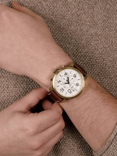 Tommy Hilfiger Jake watch worn on wrist showing white dial and brown leather strap