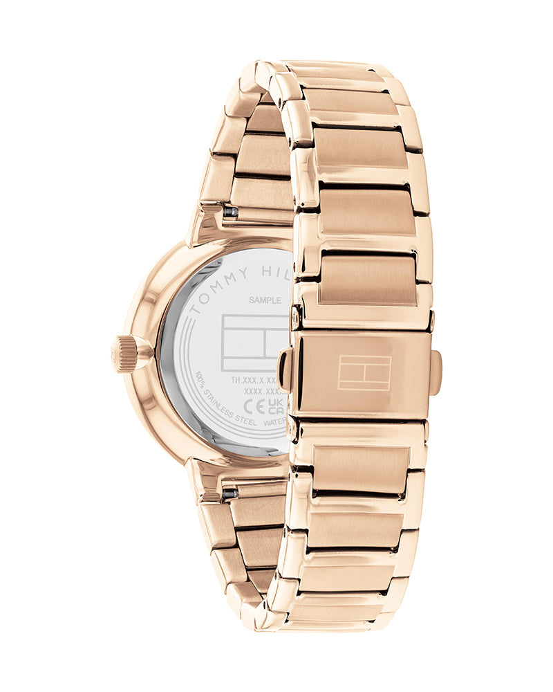 Side view of Tommy Hilfiger Joy watch with gold steel bracelet and caseback detail