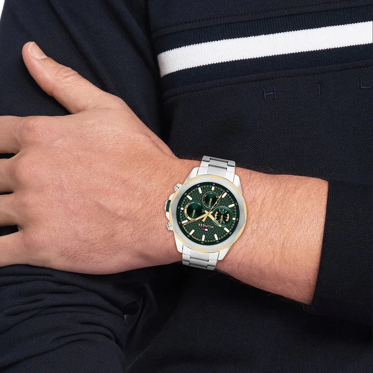 Tommy Hilfiger Lars chronograph watch worn on wrist with green dial and gold accents