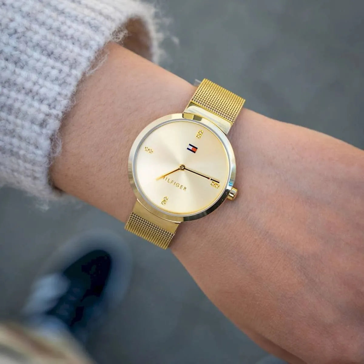 Tommy Hilfiger Liberty watch styled flat lay with gold mesh strap and champagne dial