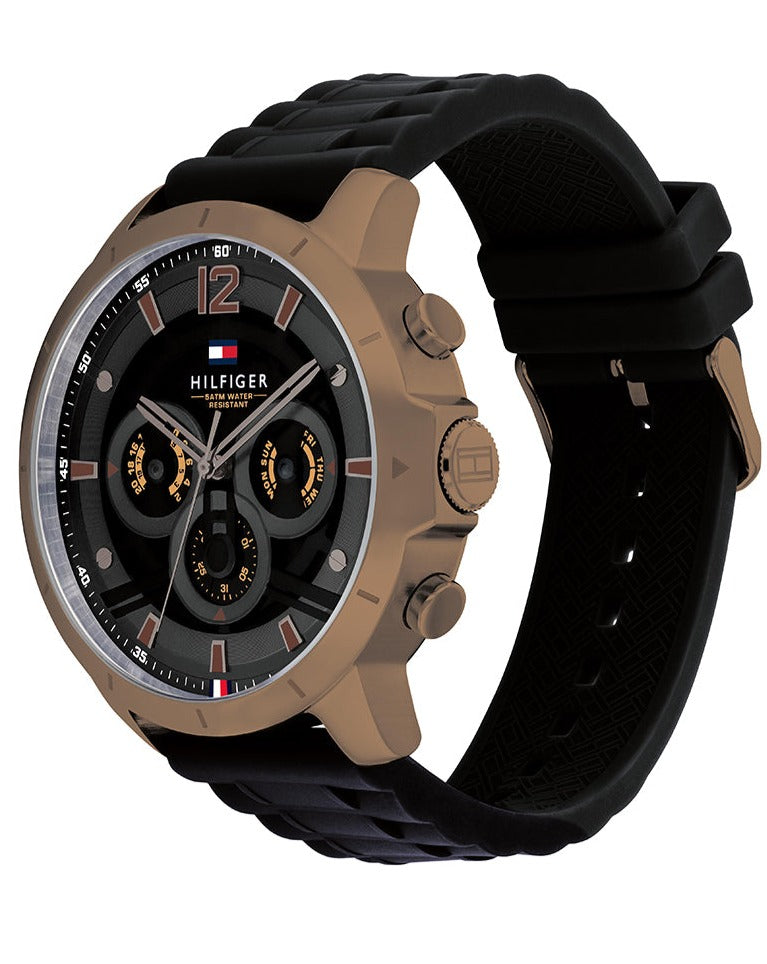 Side angle view of Tommy Hilfiger Luca watch on black rubber strap