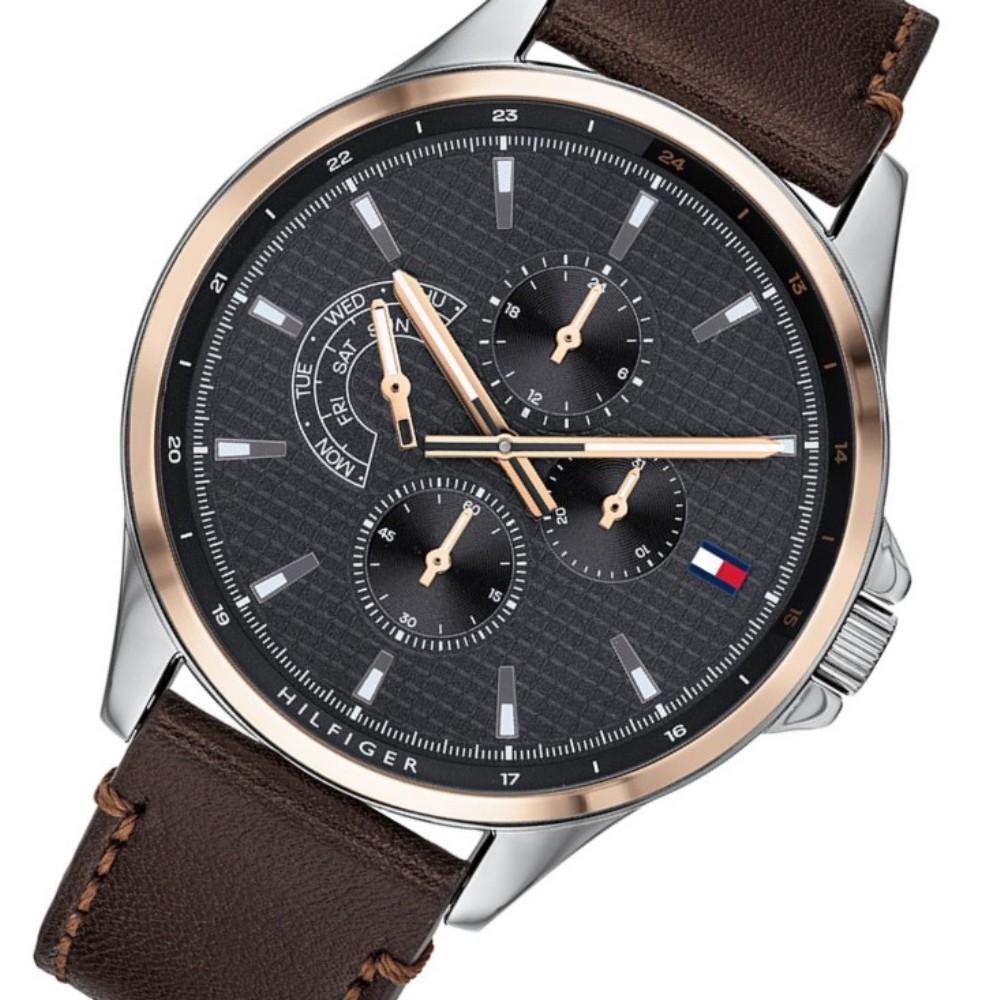 Tommy Hilfiger multifunction watch angled view showing black dial with chronograph subdials and brown leather strap
