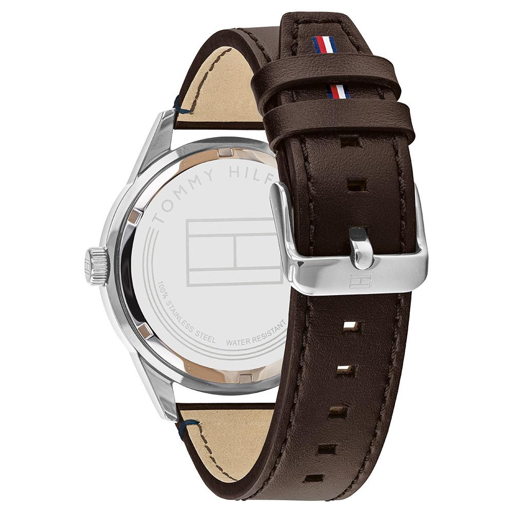 Brown leather strap detail with tan lining, Tommy Hilfiger flag logo, and adjustment holes