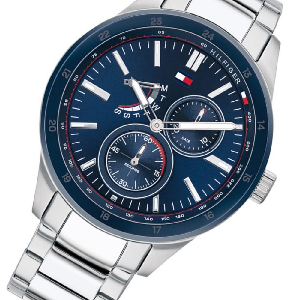 Angled view of Tommy Hilfiger multi-function steel watch showing navy dial and steel band