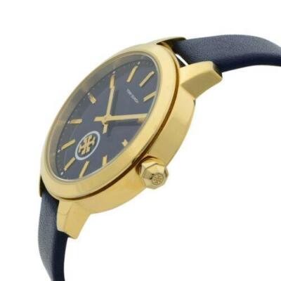 Side angle view of Tory Burch Collins watch with navy leather strap and gold case