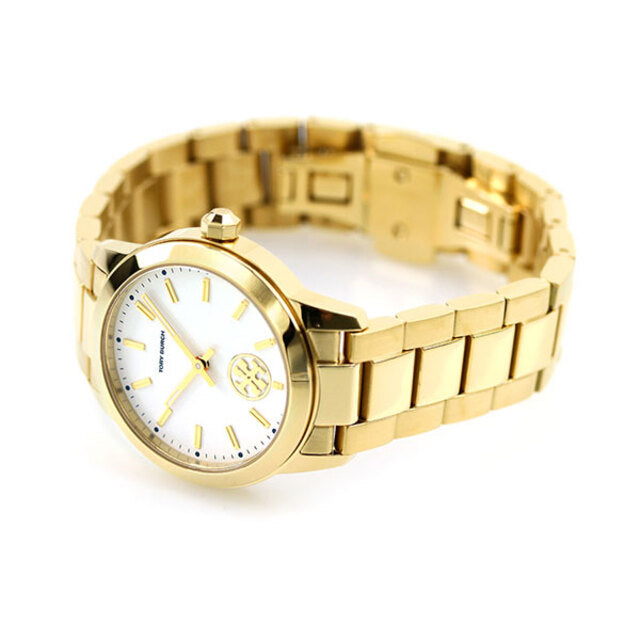 Tory Burch Collins yellow gold watch on wrist with white dial