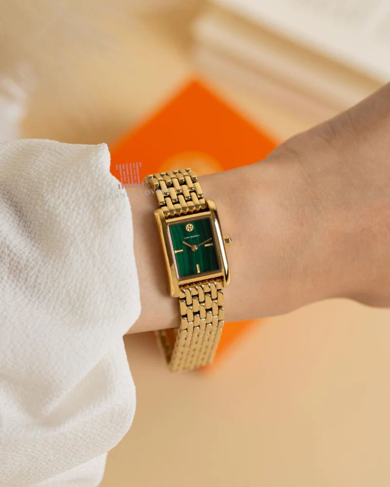 Tory Burch Mini Eleanor watch worn on wrist with green dial and gold bracelet