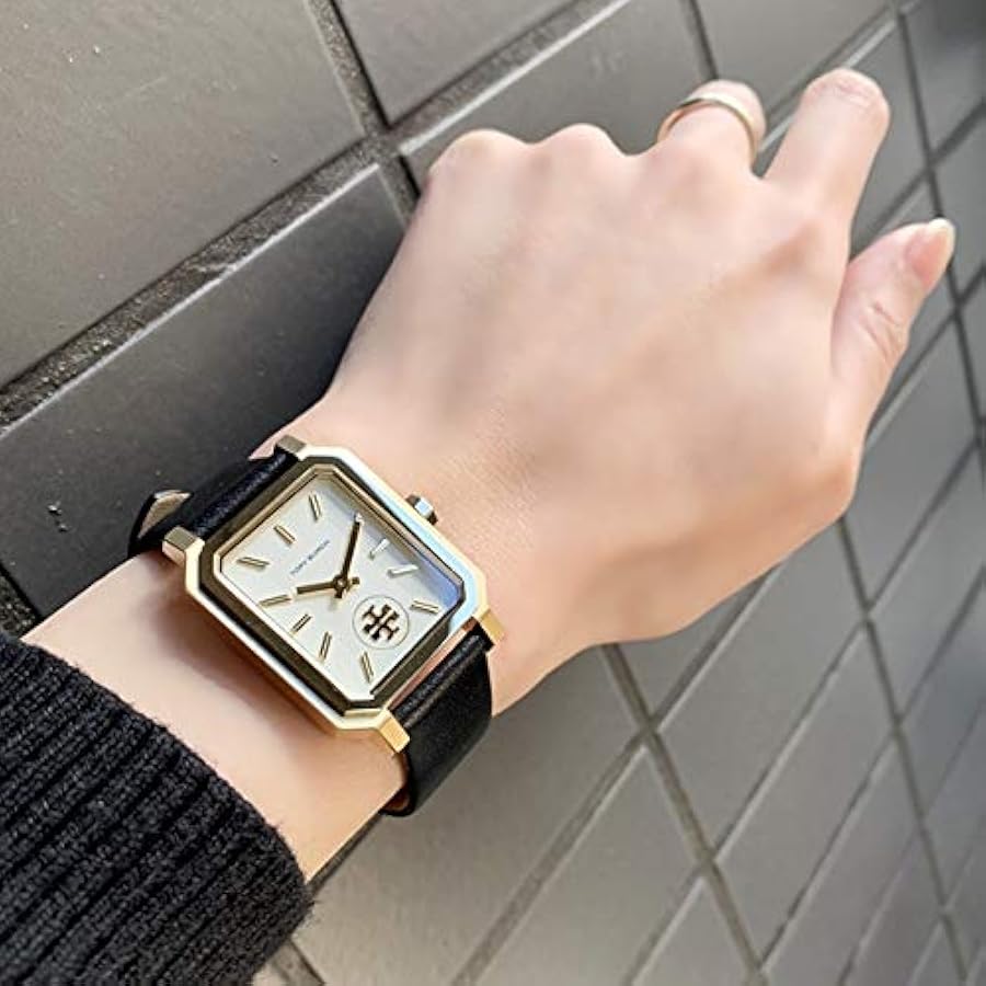 Robinson gold and black leather watch worn on woman's wrist