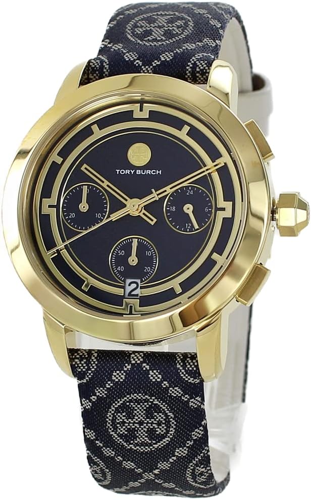 Three-quarter angle view of Tory Burch chronograph with gold-tone case, navy dial, and navy fabric with ivory leather strap