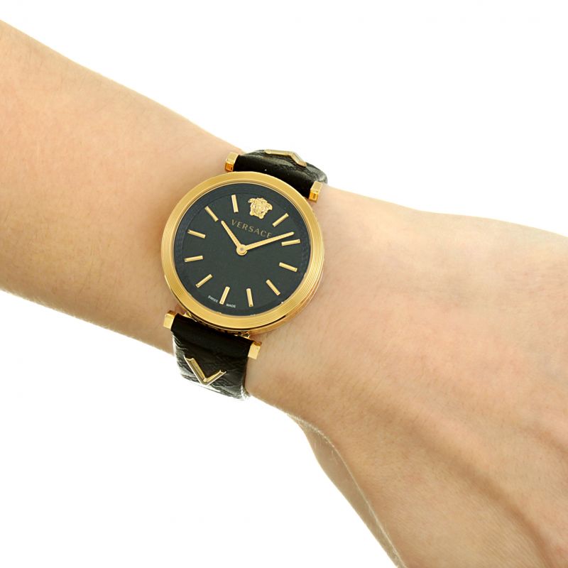 Close-up of V-Twist watch on wrist displaying dial and black leather strap detail