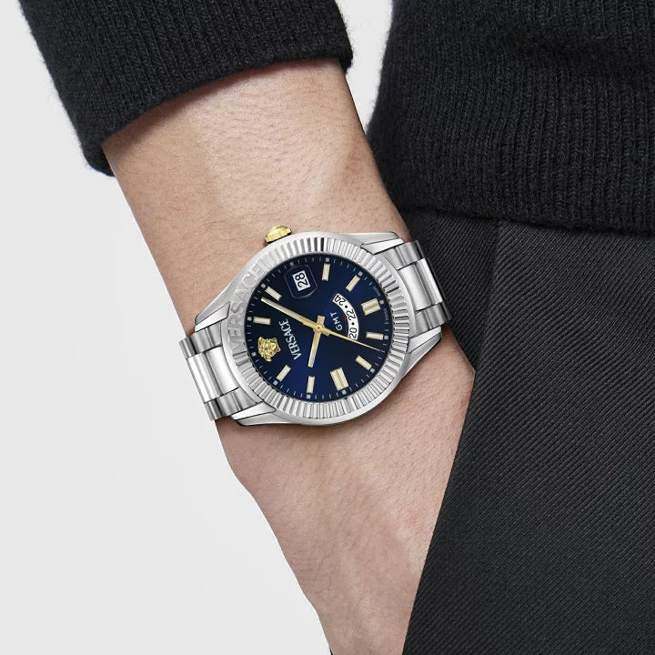 Versace Apodis watch worn on wrist, silver bracelet and blue dial with gold accents