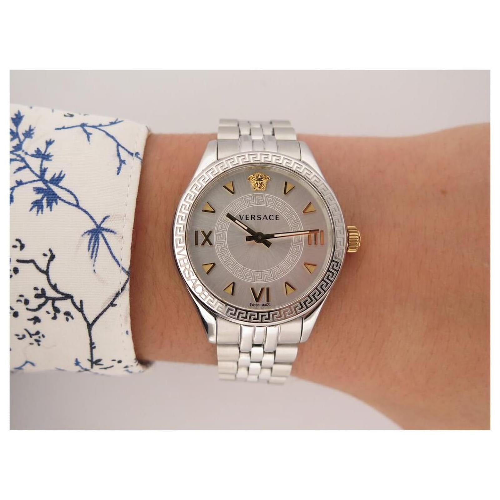 Versace Hellenyium watch worn on wrist with patterned sleeve detail