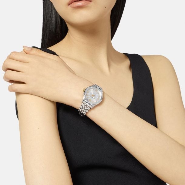 Versace Hellenyium ladies watch on wrist showing silver dial with gold accents