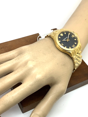 Versace Hellenyium watch worn on wrist showing black dial with gold-tone case
