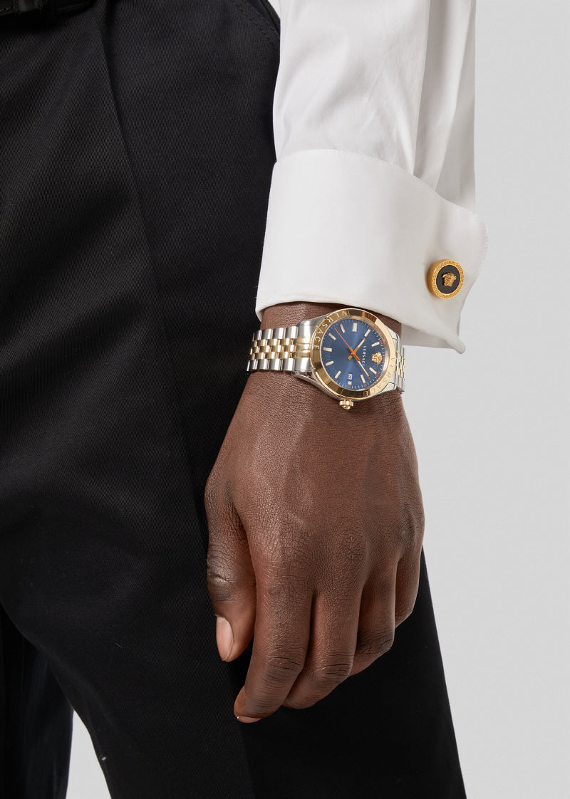 Versace Hellenyium men's watch worn on wrist with blue dial and mixed metal bracelet
