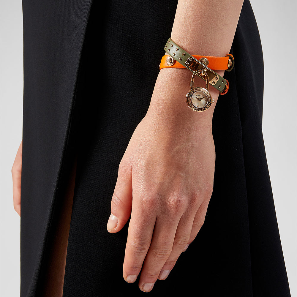 Versace Medusa Lock Icon watch worn on wrist with green leather strap and rose gold Medusa charm pendant