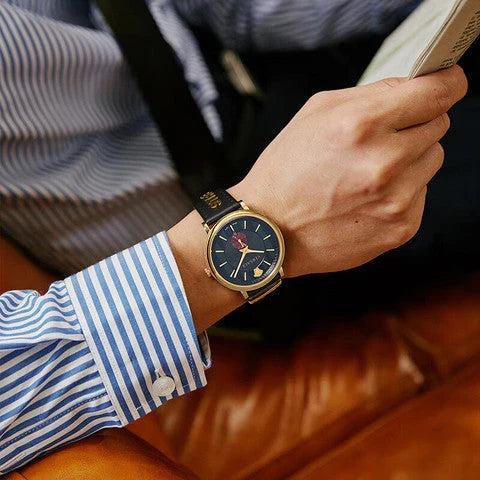Versace V-Circle Manifesto watch worn on wrist with striped shirt cuff