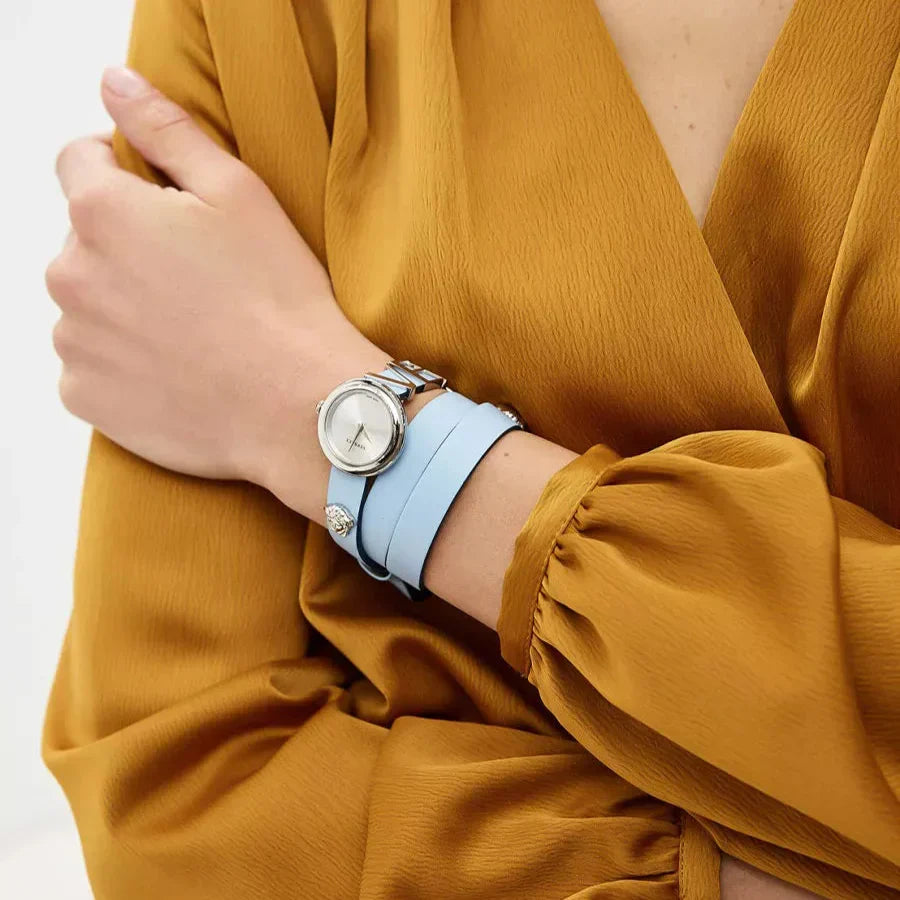 Versace V-Flare watch worn on wrist with silver case and light blue leather strap