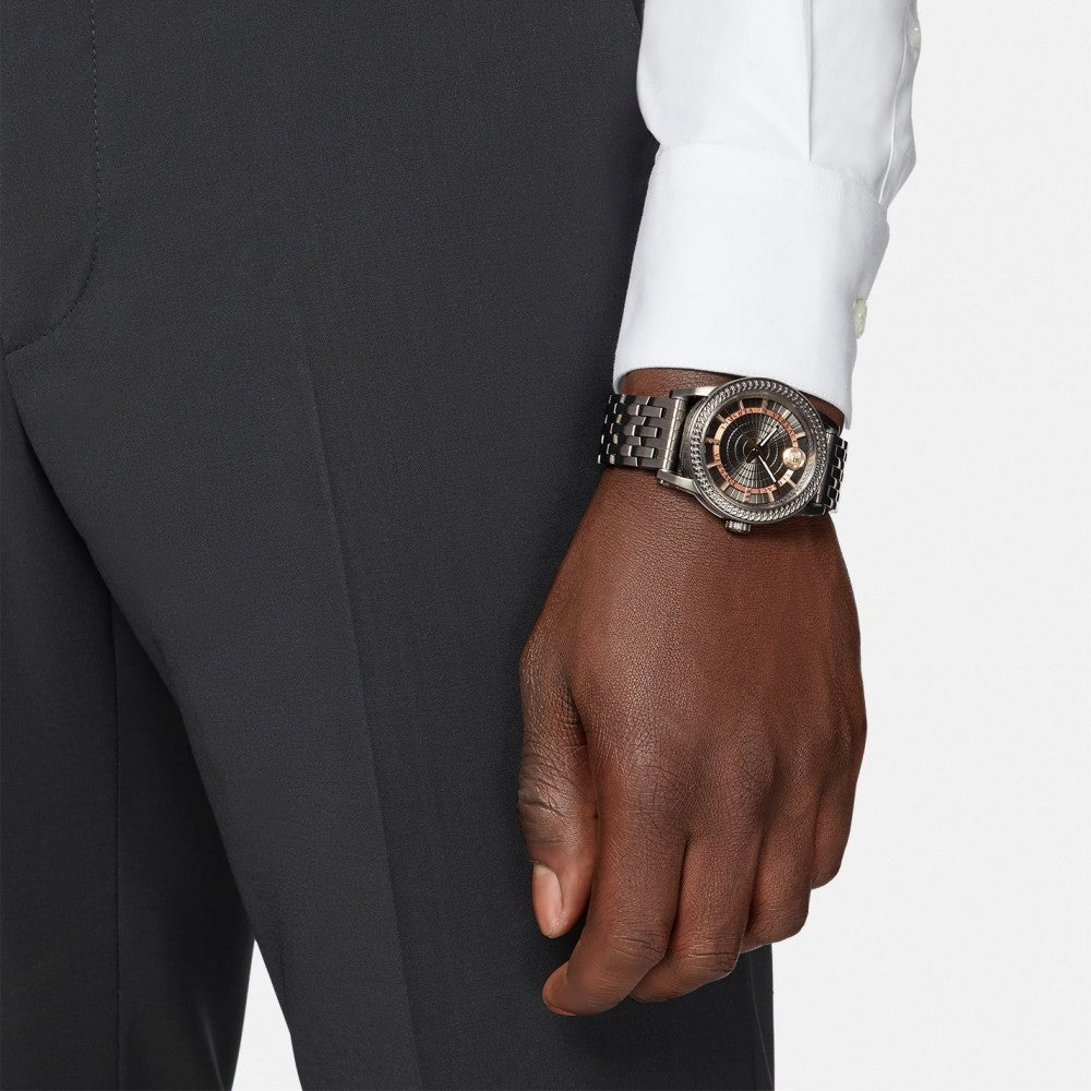 Versace Viamond all-black watch worn on wrist with business formal attire