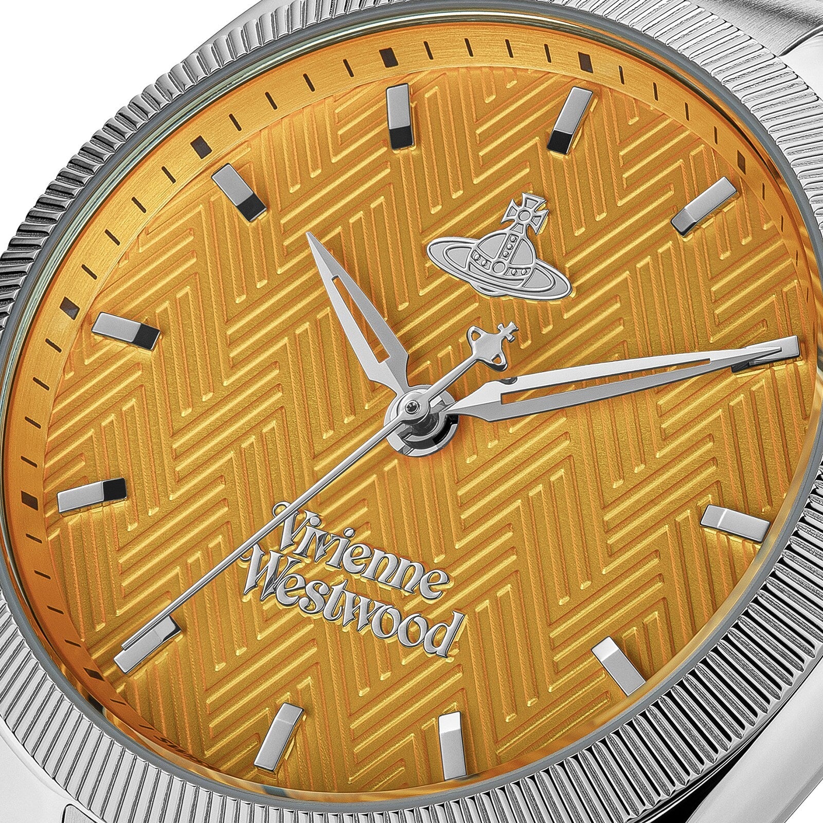 Close-up of golden dial with chevron pattern, silver hands, and Vivienne Westwood logo